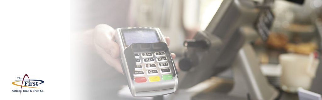 The First National merchant services with business banking debit and credit card scanner